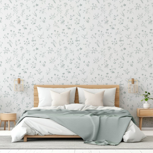 Nola Wallpaper In Bedroom With Wooden Frame Bed With Sage Blanket And Plants Either Side of The Bed