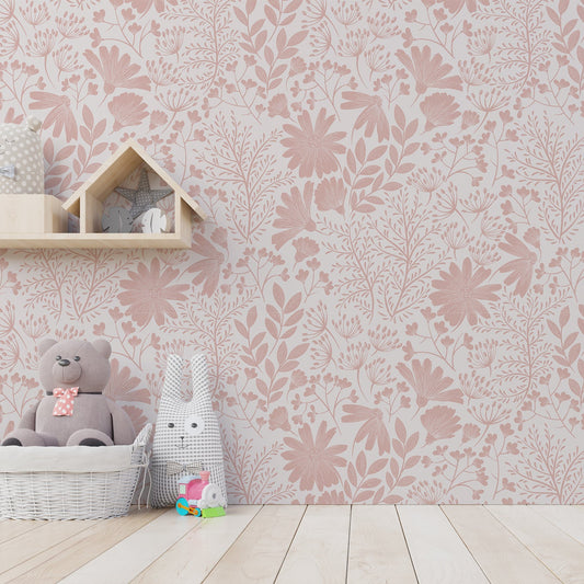 A children's room with soft toys showing 'Marissa' which is a chinoiserie-inspired wallpaper with pink floral silhouettes and fine white botanical outlines on a white background.