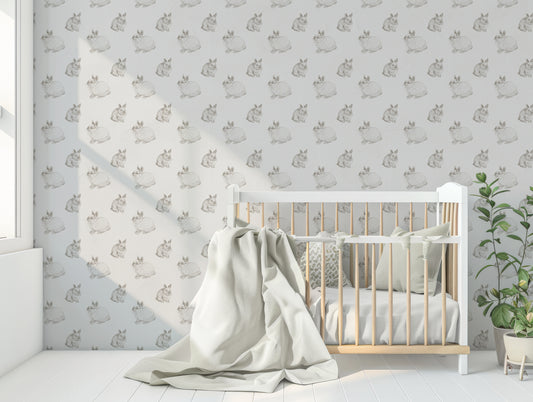 Kristy Wallpaper In Nursery Room With Baby Blue Cot & Large Blanket & Green Leafy Plant