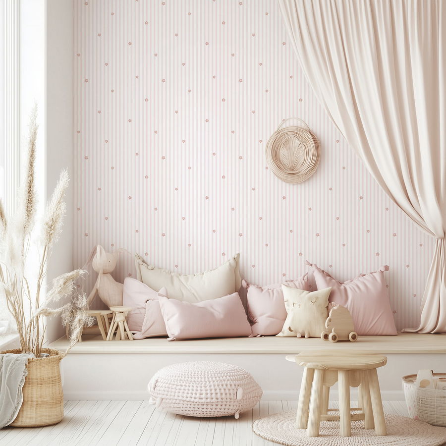 A children's playroom with a light coloured bench with pillows and toys scattered across it with rattan furniture featuring the Sophia wallpaper which is pinstripe with small floral sprigs on a cream background in a vintage-inspired repeating design.