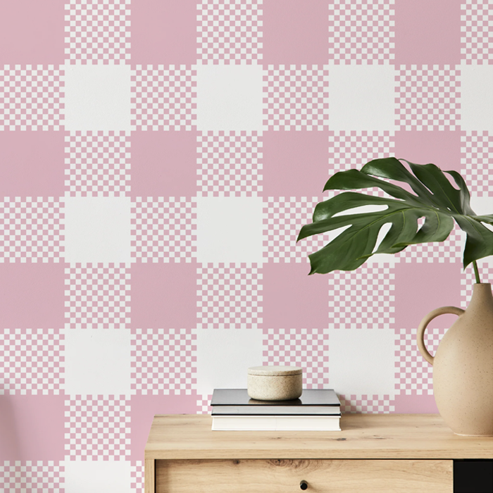 April pink plaid wallpaper on a hallway wall with an oak console table and monstera