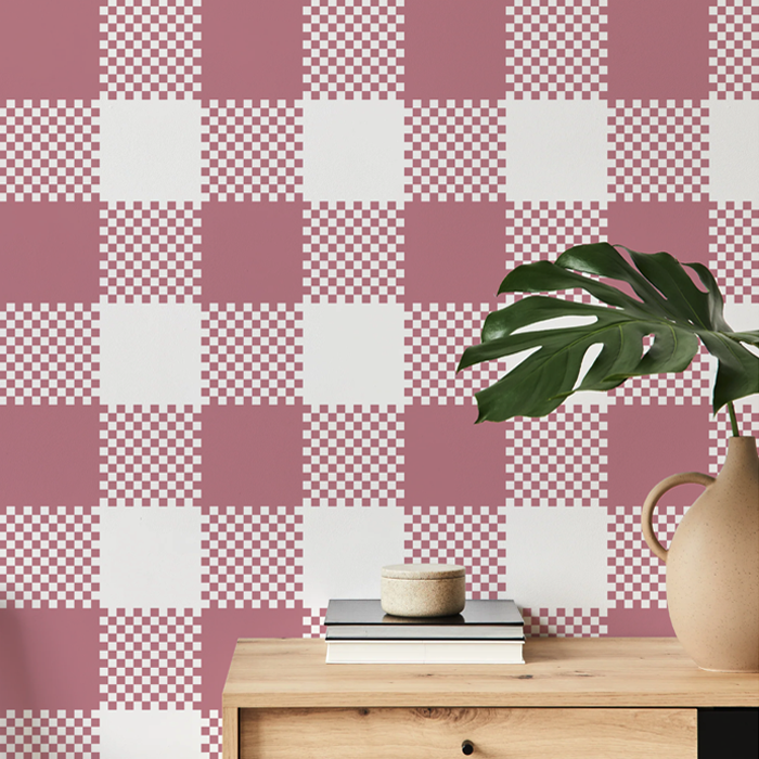 bonbon pink plaid wallpaper on a hallway wall with an oak console table and monstera