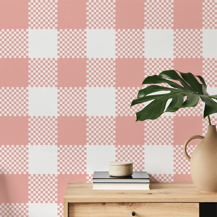 conch pink plaid wallpaper on a hallway wall with an oak console table and monstera
