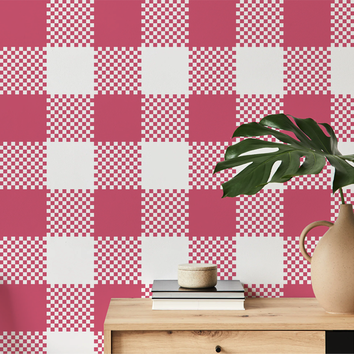 rose pink plaid wallpaper on a hallway wall with an oak console table and monstera