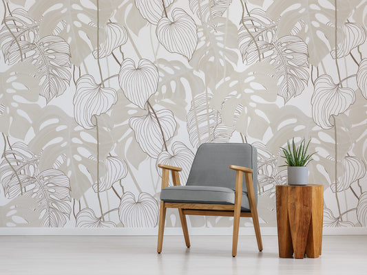 Daphne Neutral Monstera Leaf Wallpaper with Grey Chair and Cactus