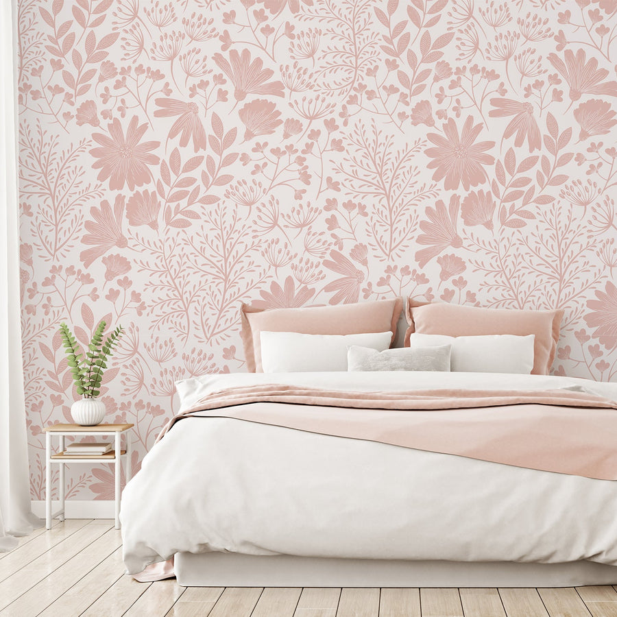 A bedroom with white and pink coloured bedding showing 'Marissa' which is a chinoiserie-inspired wallpaper with pink floral silhouettes and fine white botanical outlines on a white background.